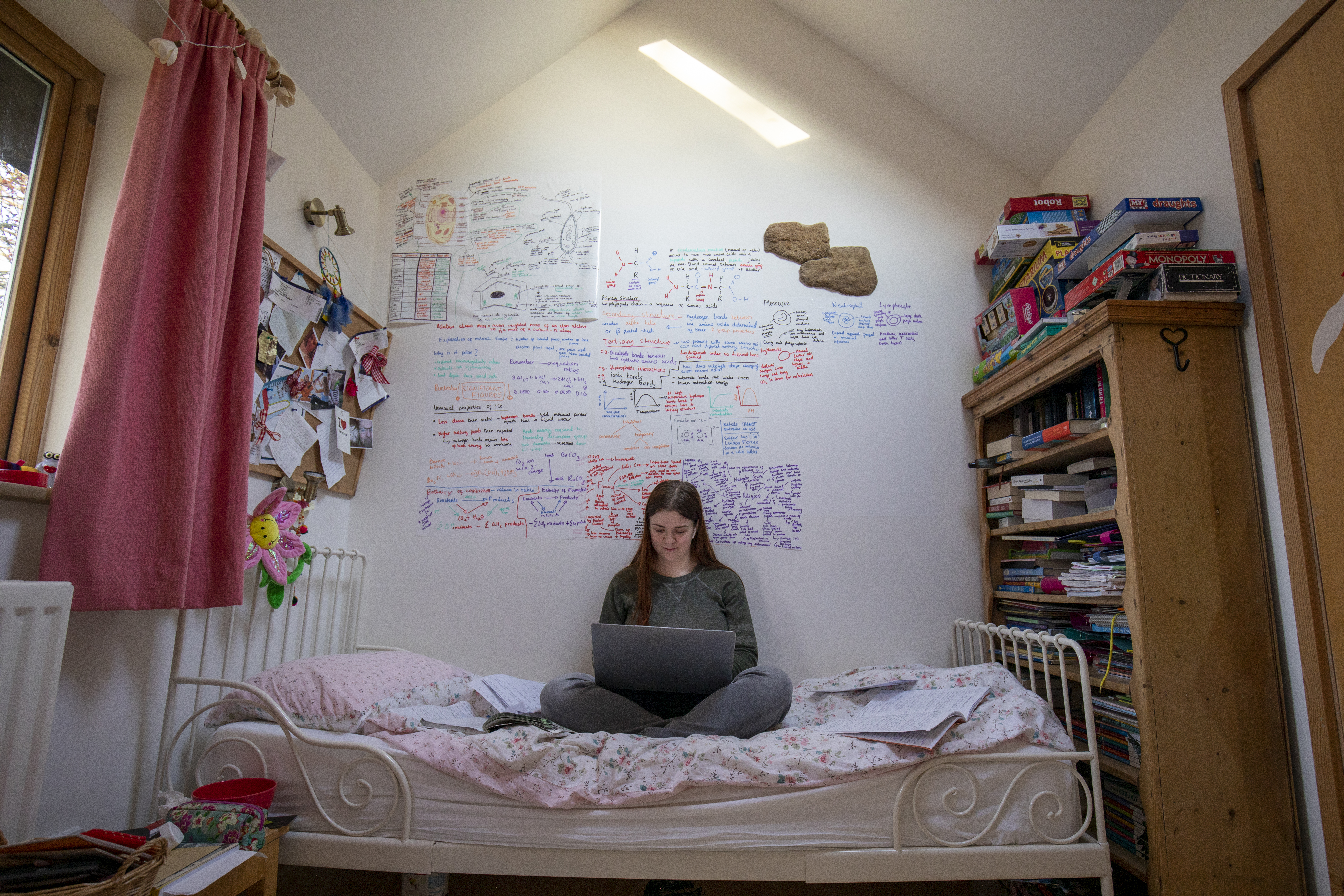 A student studying in their bedroom.