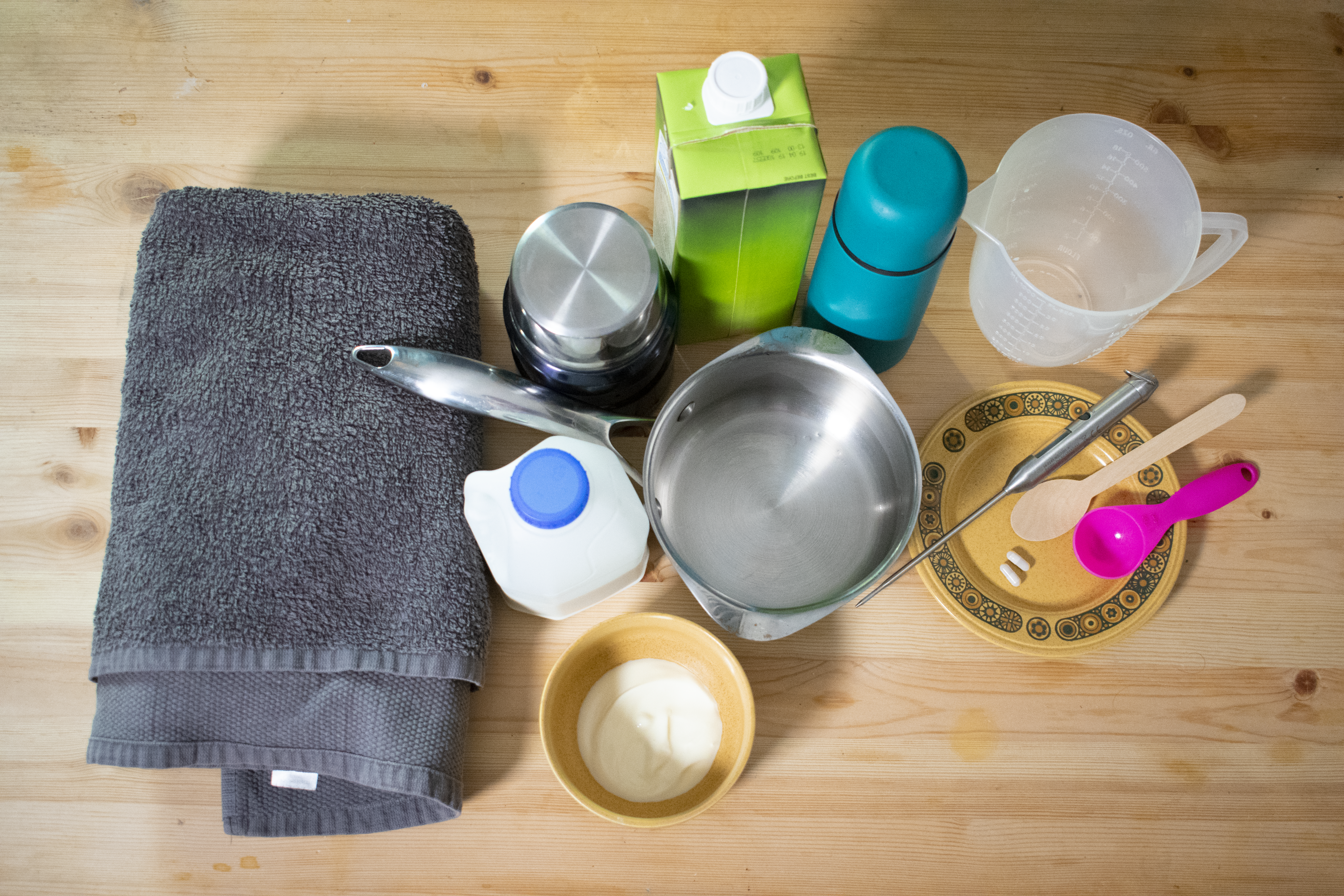 A picture of the equipment required for the experiment: saucepan, milk, soy milk, flask, towel, measuring jug, measuring spoons, natural yoghurt