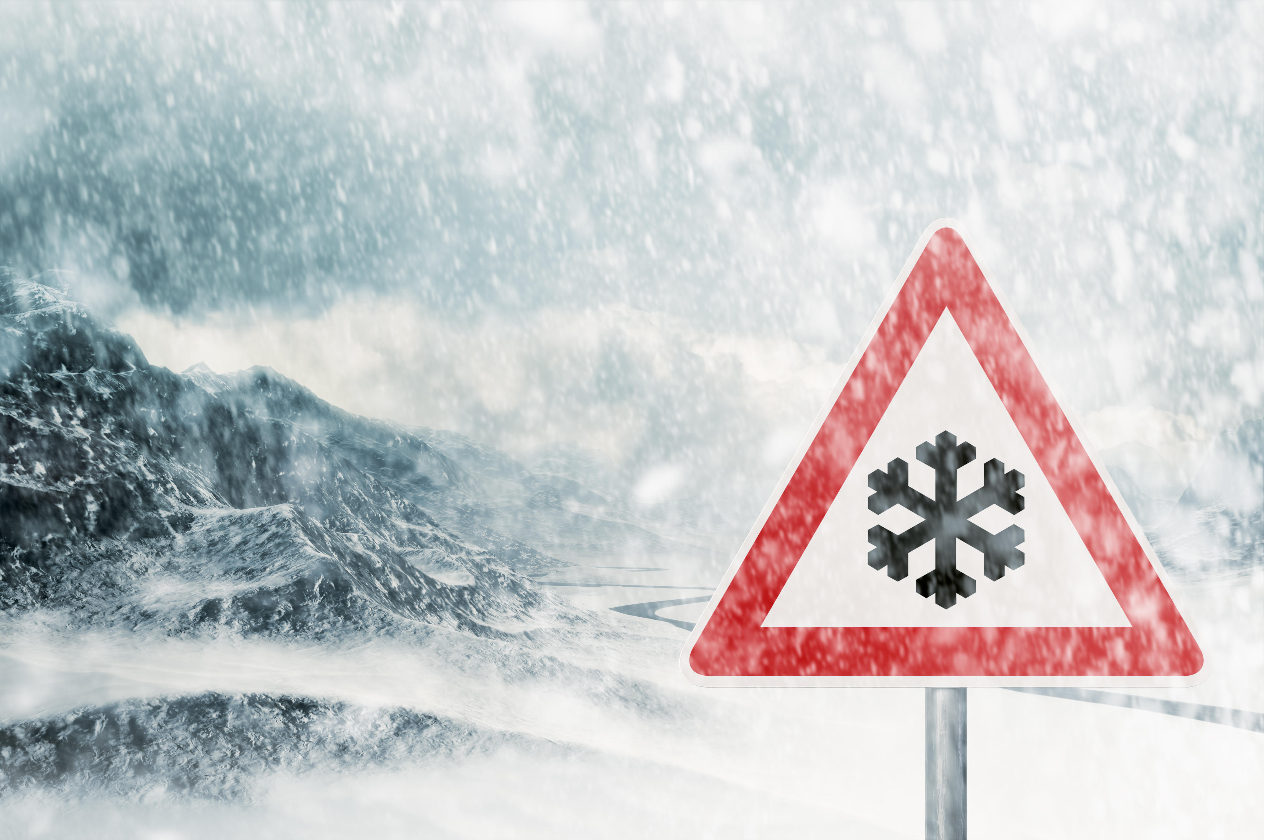 A traffic sign signalling snow, in a blizzard