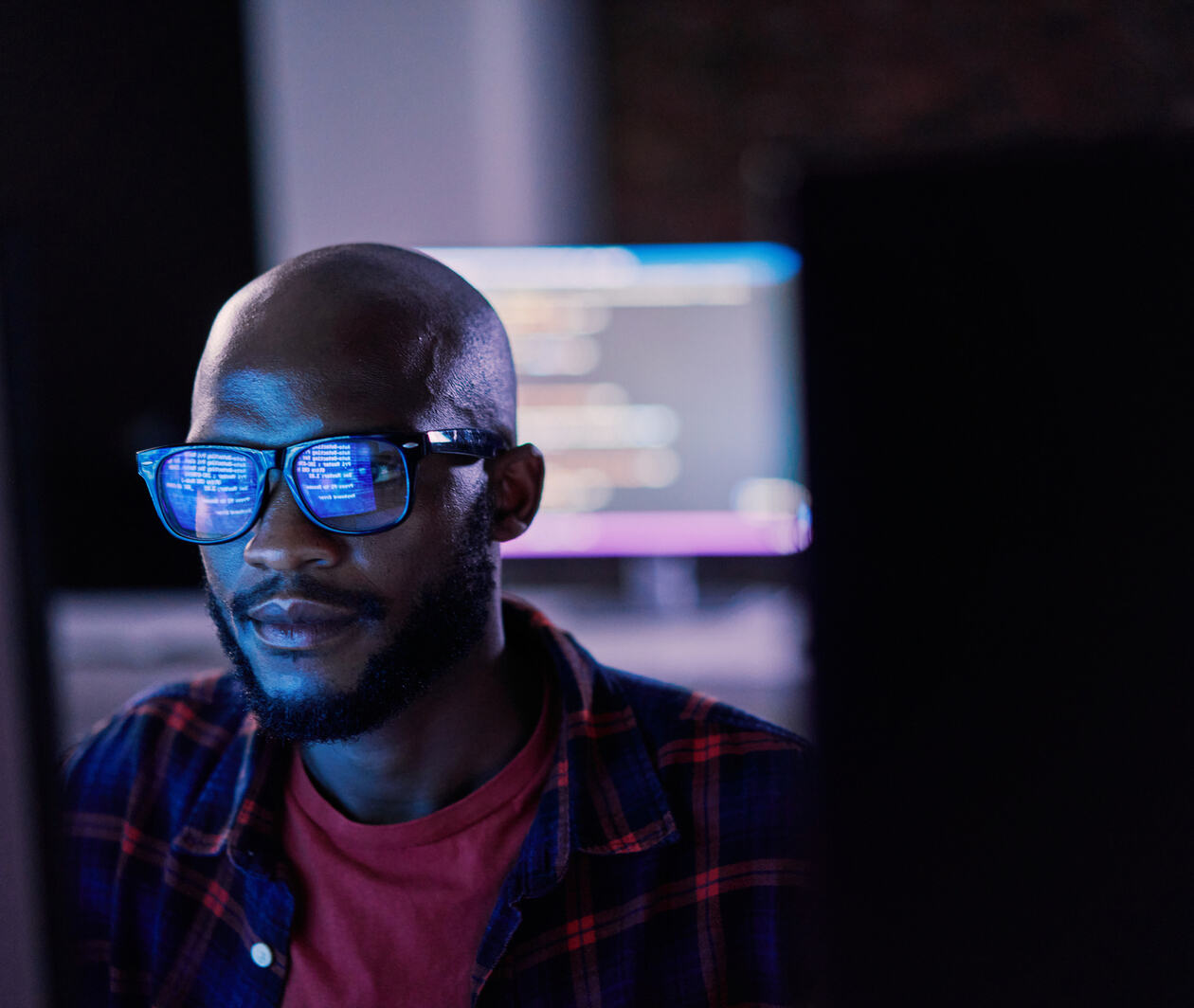 Cyber security, black man and code reflection in eyewear, hacking and software update in office. African American male employee, programmer or IT specialist with glasses, focus and cloud computing
