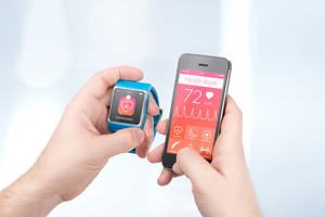 A smart watch and iPhone running health apps