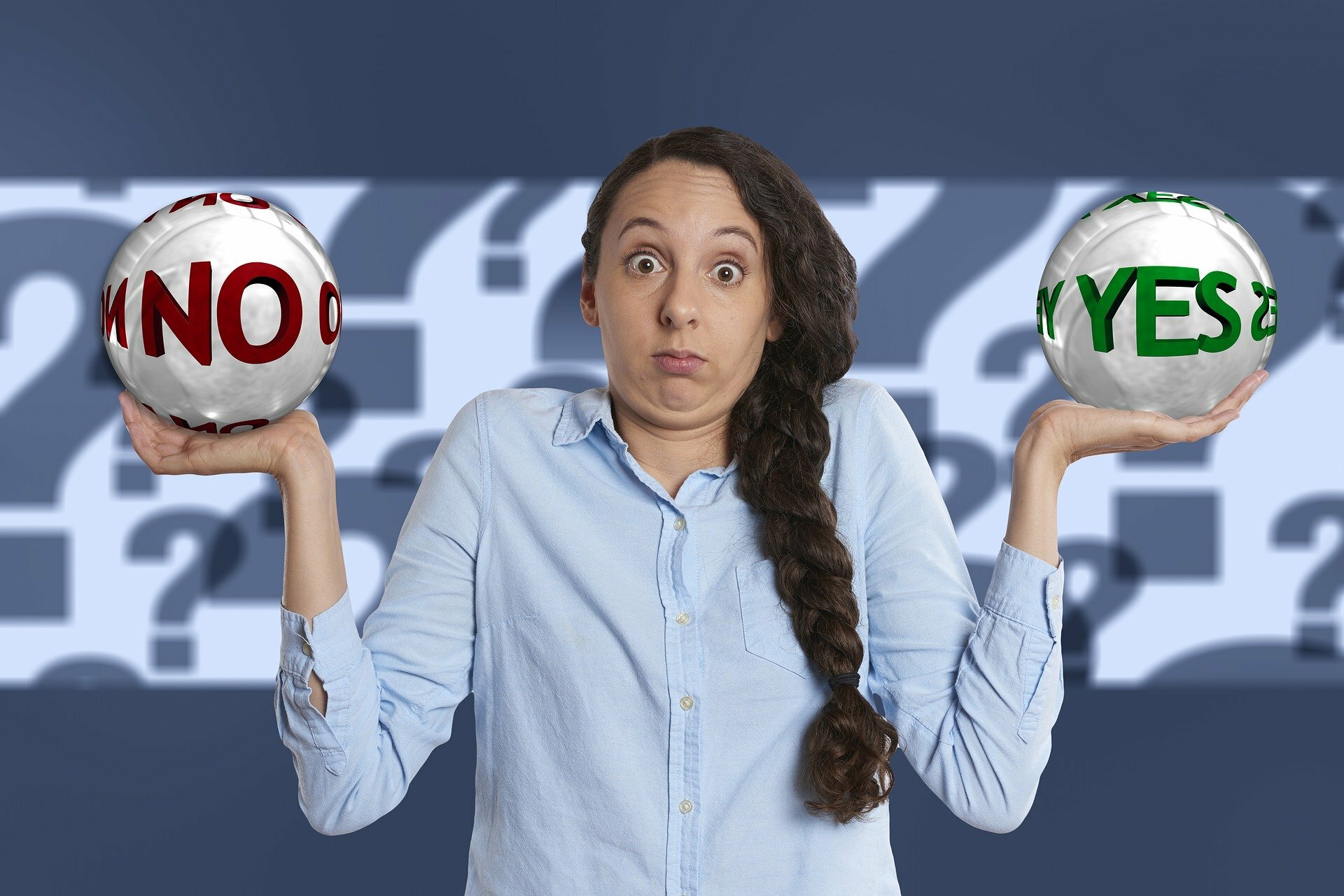 Photo of a confused woman, holding a No ball and a Yes ball