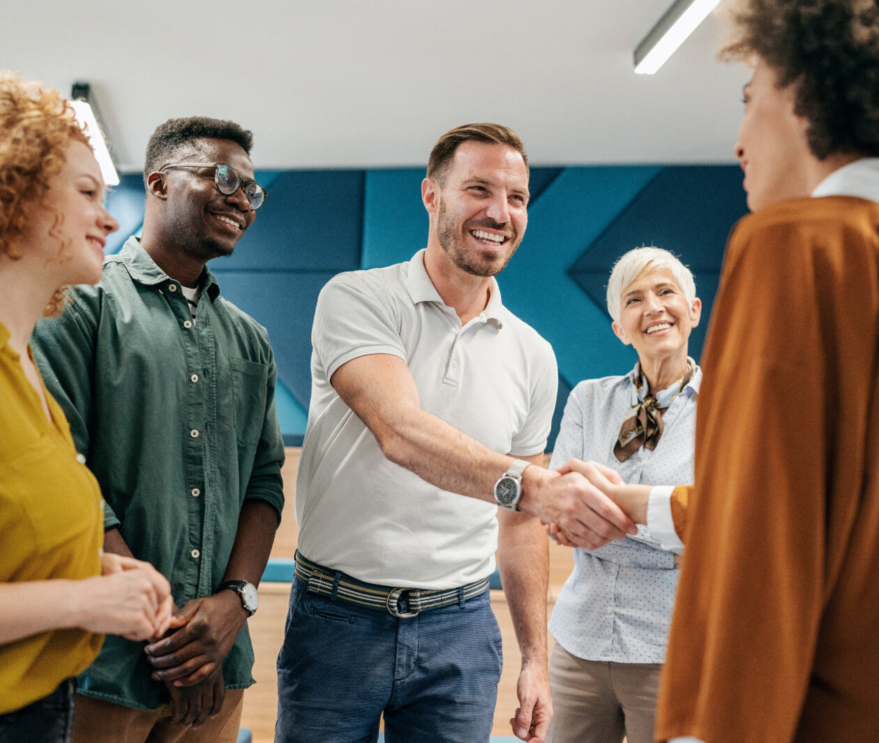 Happy businessman shaking hands with colleague on a meeting in the office.