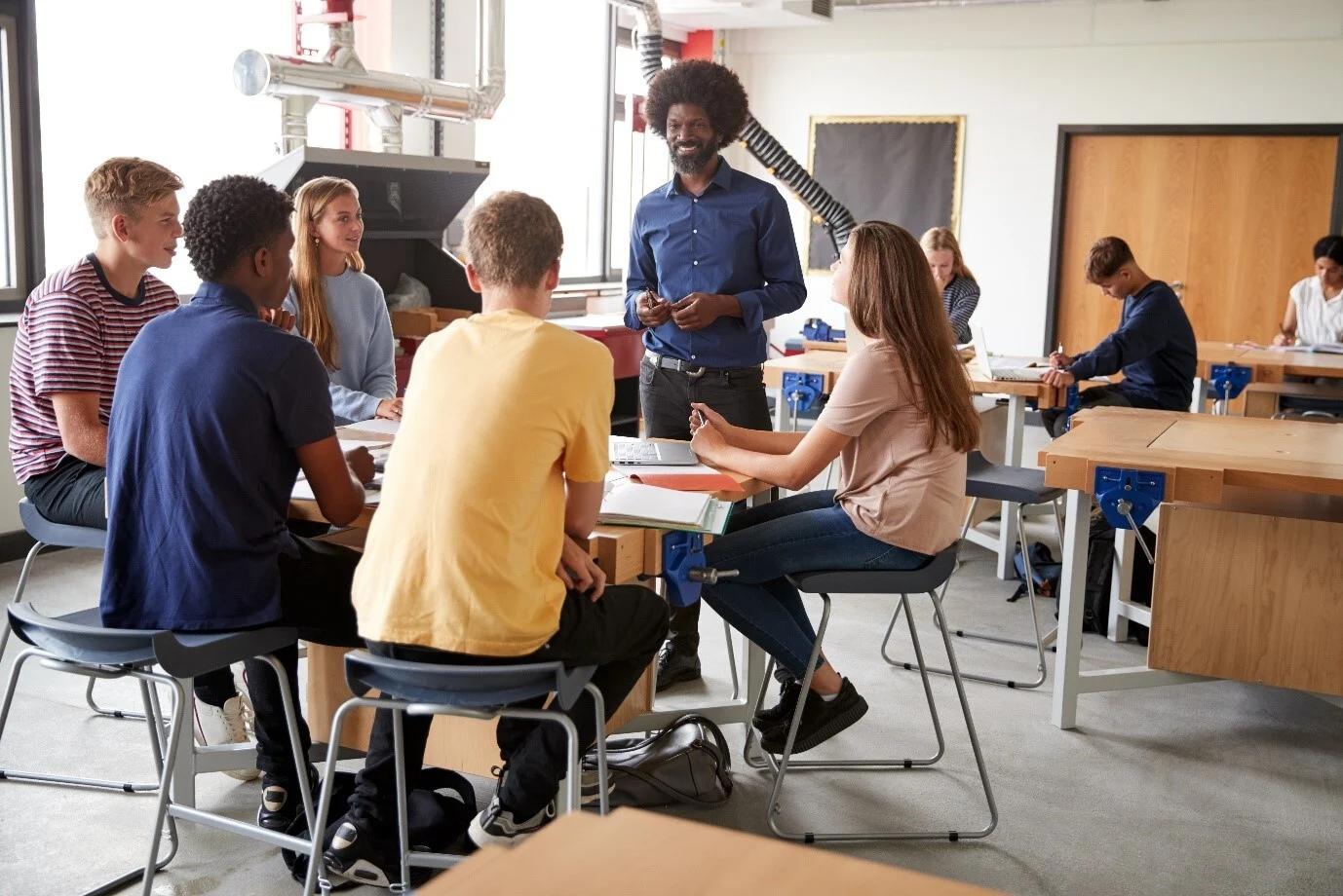 Secondary teacher and students in a technology lab