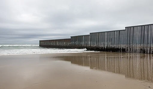 A large wall at the border between the US and Mexico