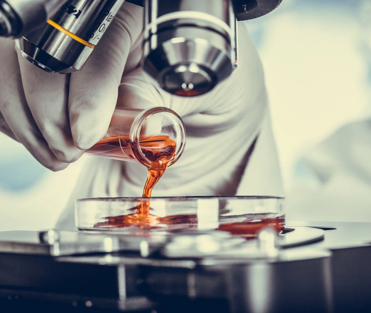 a photo of someone viewing a substance under a microscope