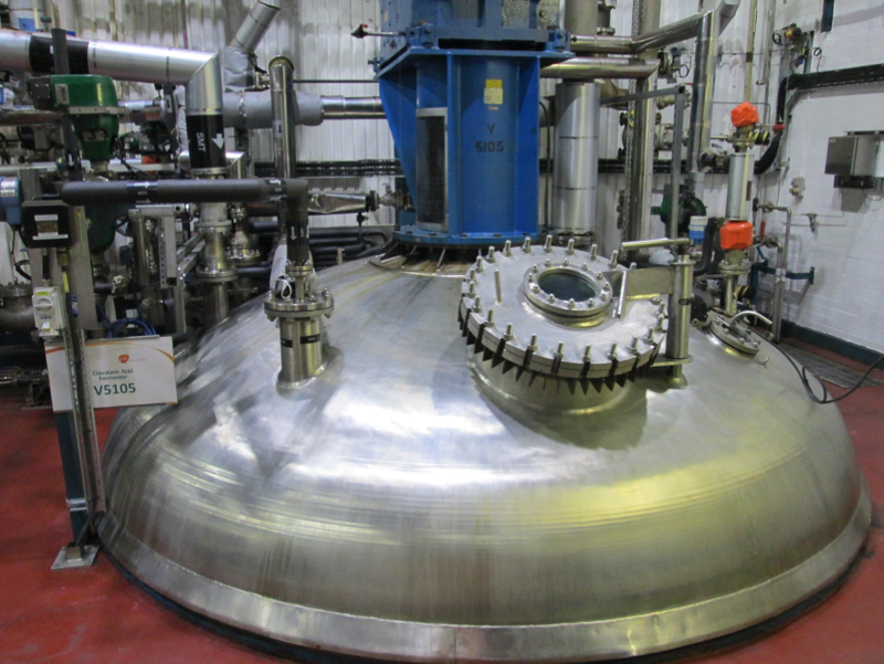 Picture of one of GSK Irvine's clavulanic acid production fermenter. This is housed in a three story building with the fermenter passing through the whole building. The top of the vessel is accessible from third floor and includes a viewing port.