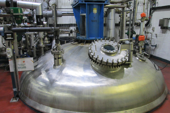 Picture of one of GSK Irvine's clavulanic acid production fermenter. This is housed in a three story building with the fermenter passing through the whole building. The top of the vessel is accessible from third floor and includes a viewing port.