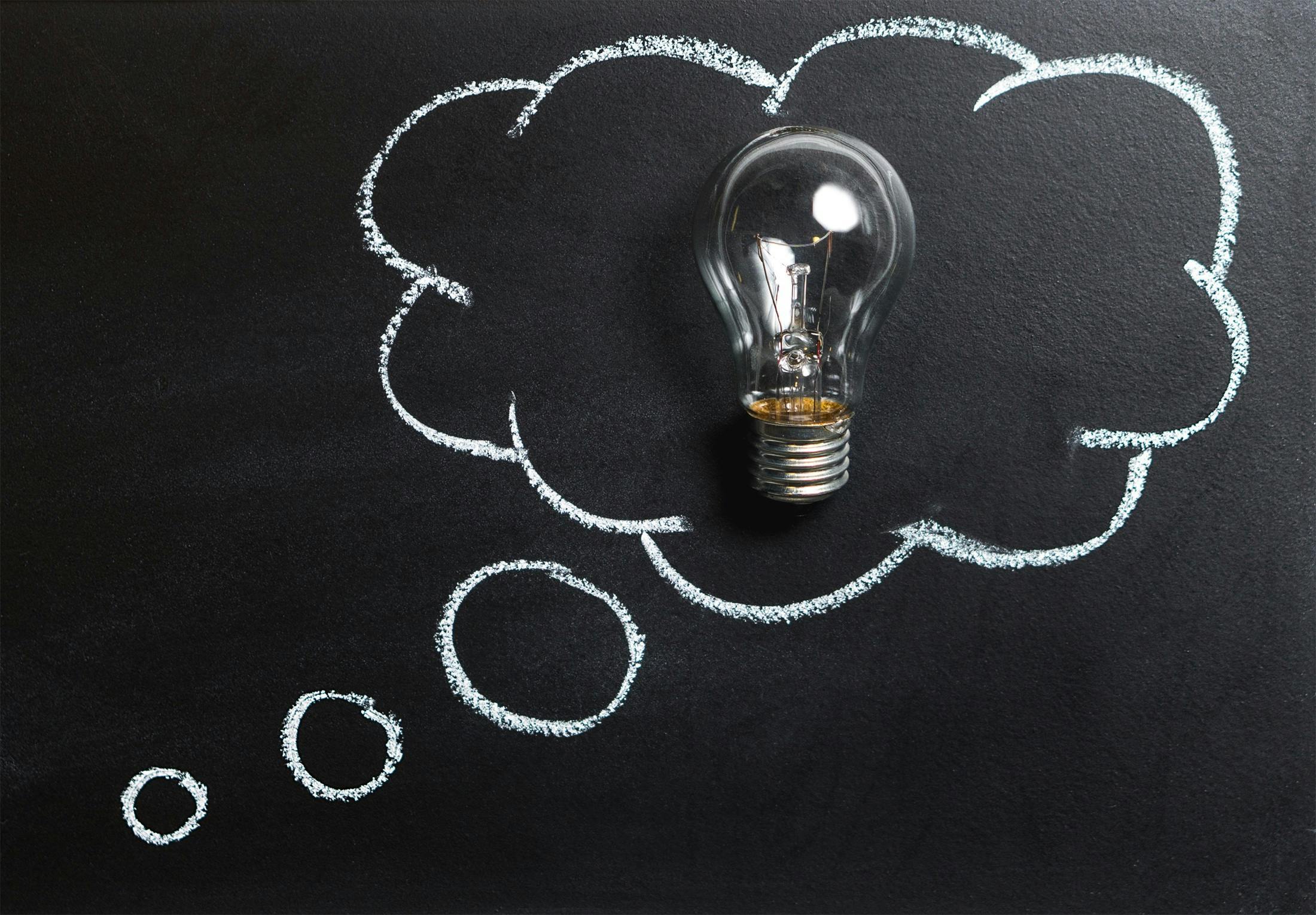 light bulb in a thunking cloud drawn on a blackboard