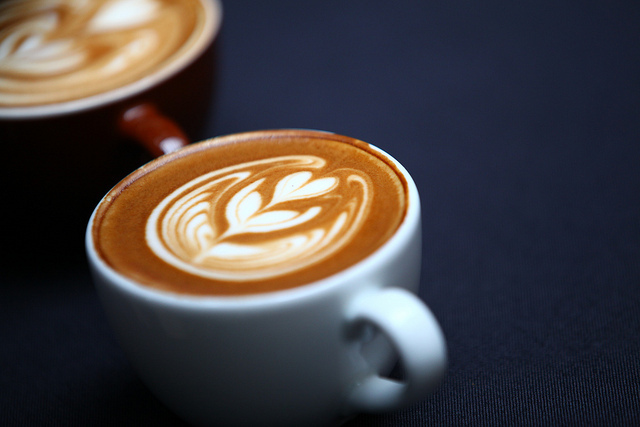 Coffee shop scene Cup of coffee with a heart shape in the foam