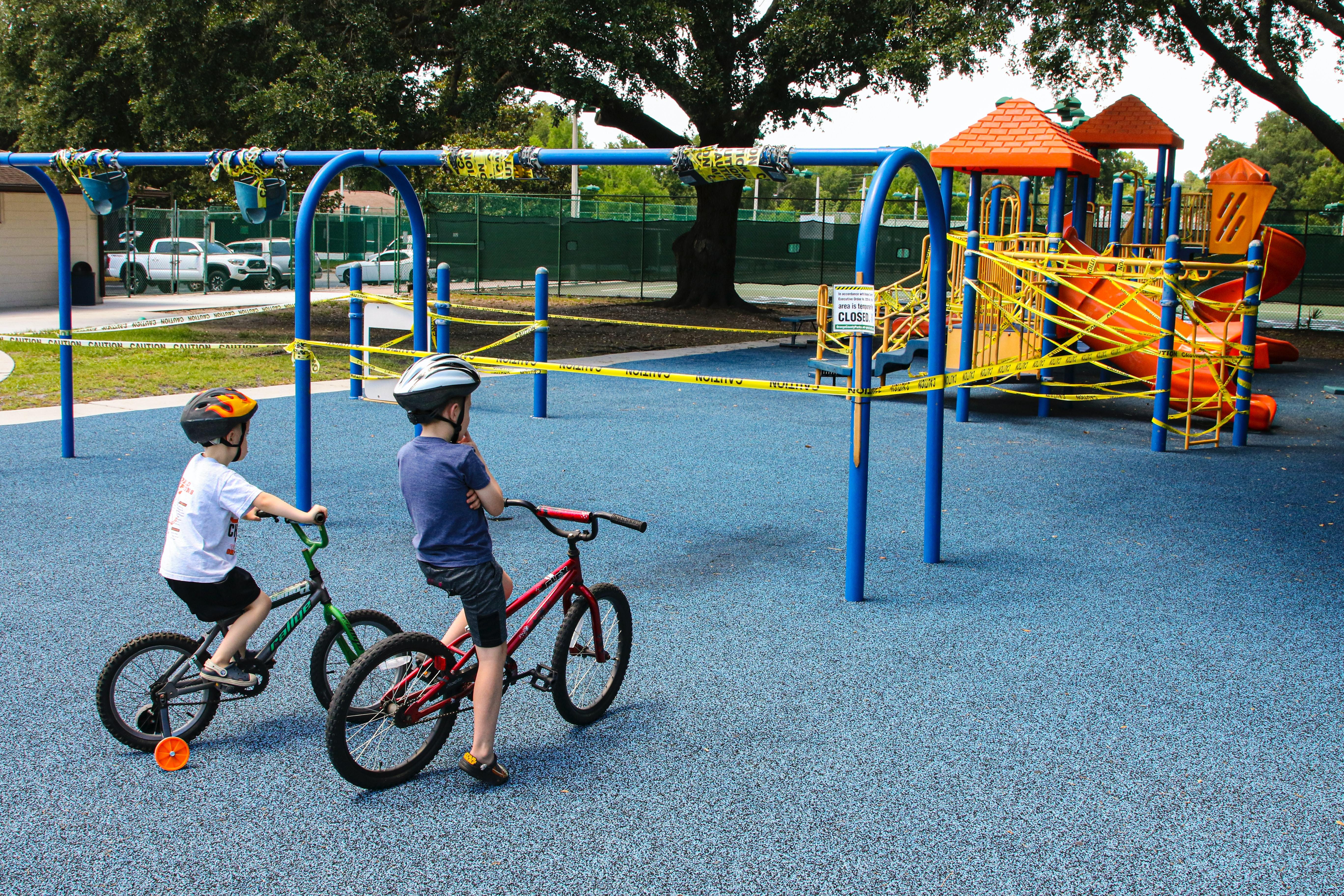 Two young boys looking at a closed playground