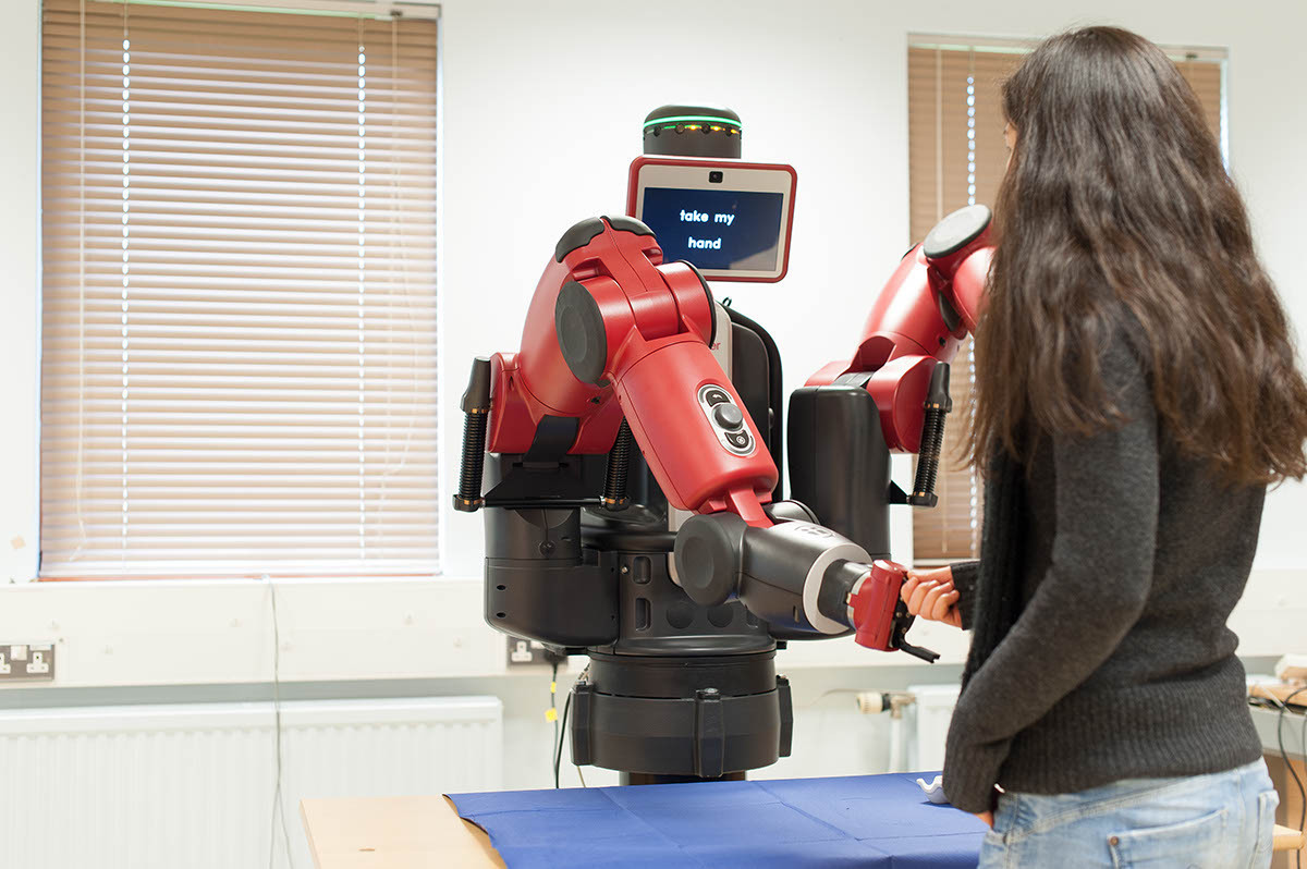 Baxter robot at the University of Reading 'shaking hands' with a student