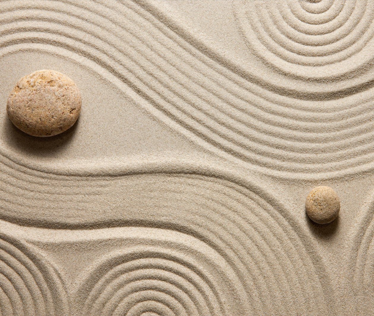 Image of Zen garden with swirling sand patterns around rocks.  This image represents a free online course on Mindfulness for Wellbeing and Peak Performance.