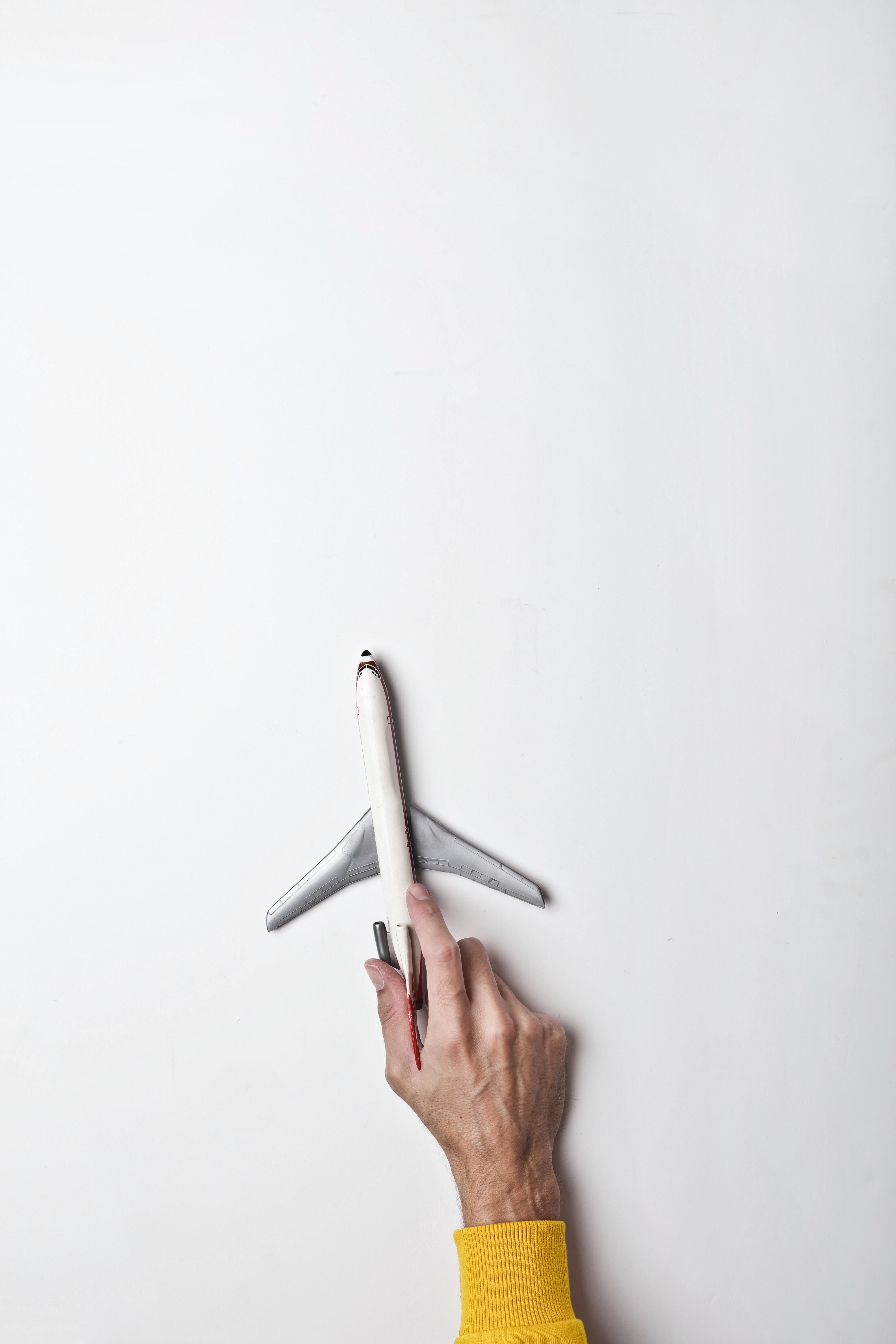 hand pushing a toy plane