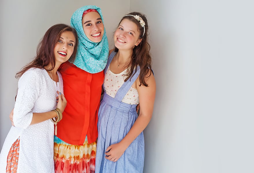 three young women of different faiths posing for a photo