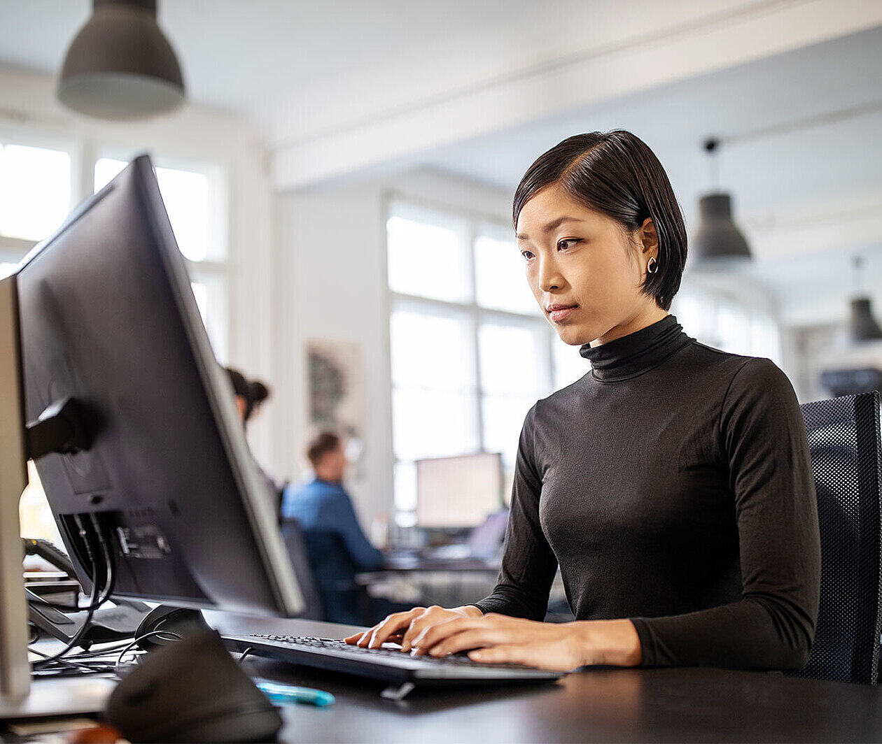 Person working at a desktop computer.