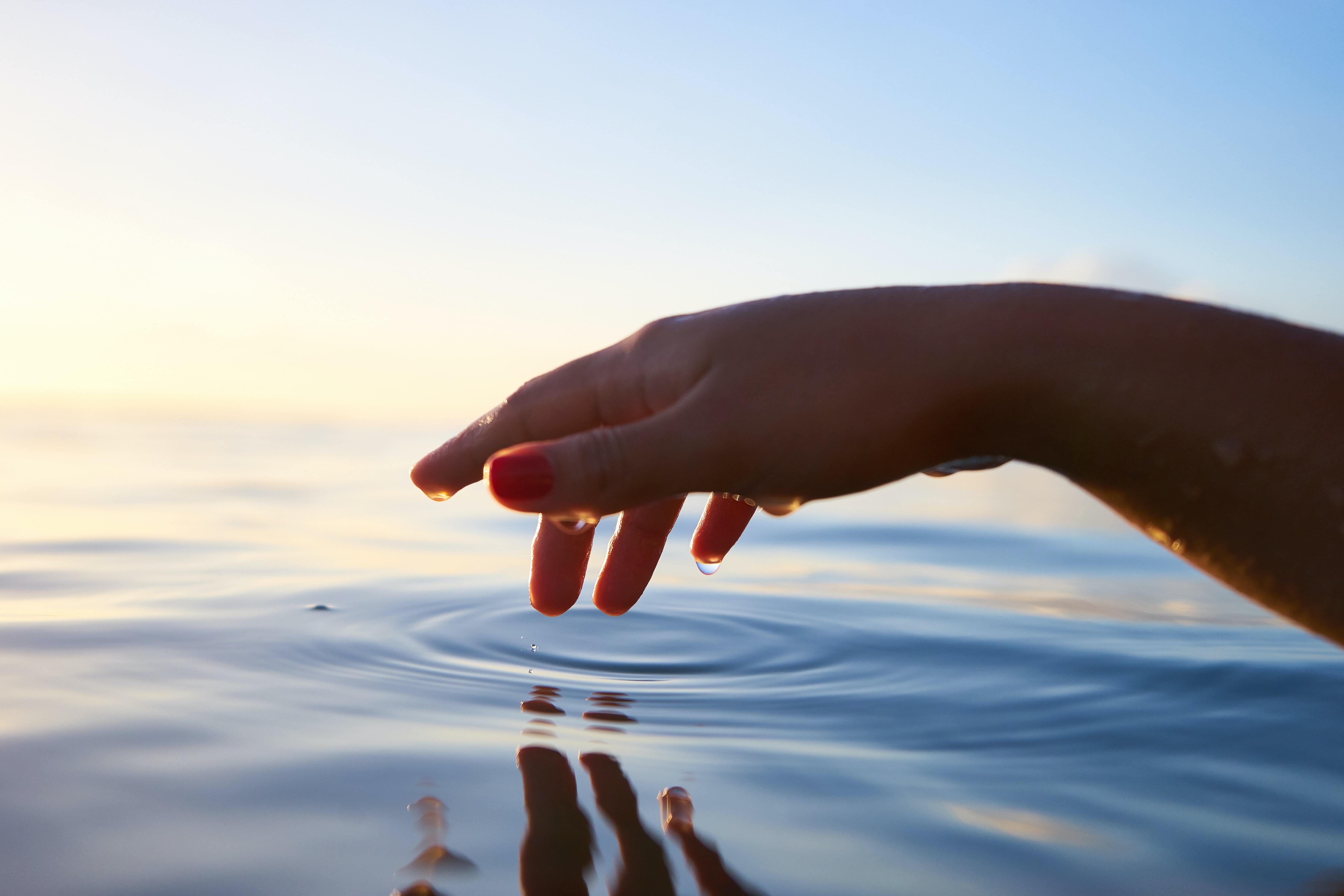 Women lightly touching water