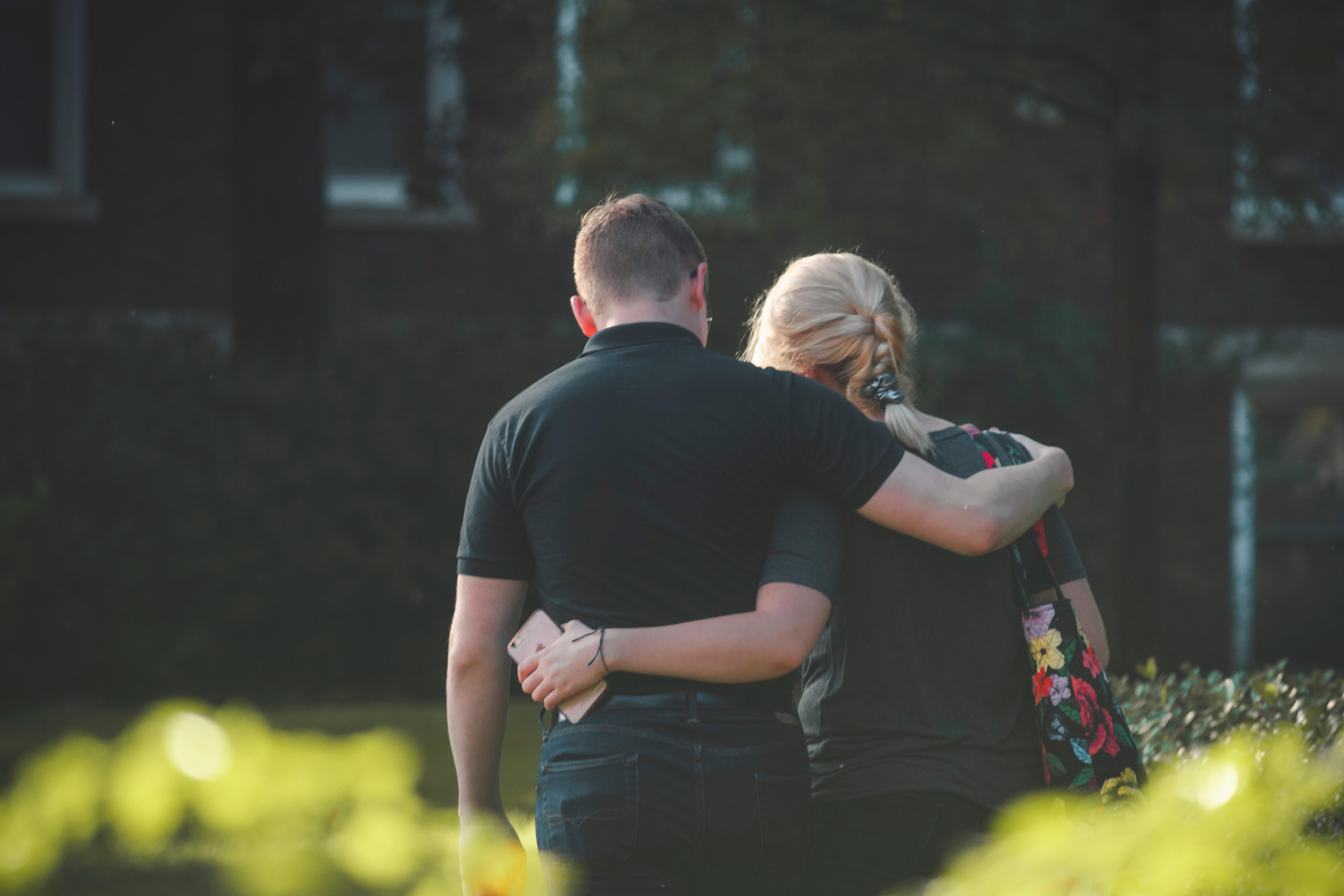 couple walking arm in arm shot from behind