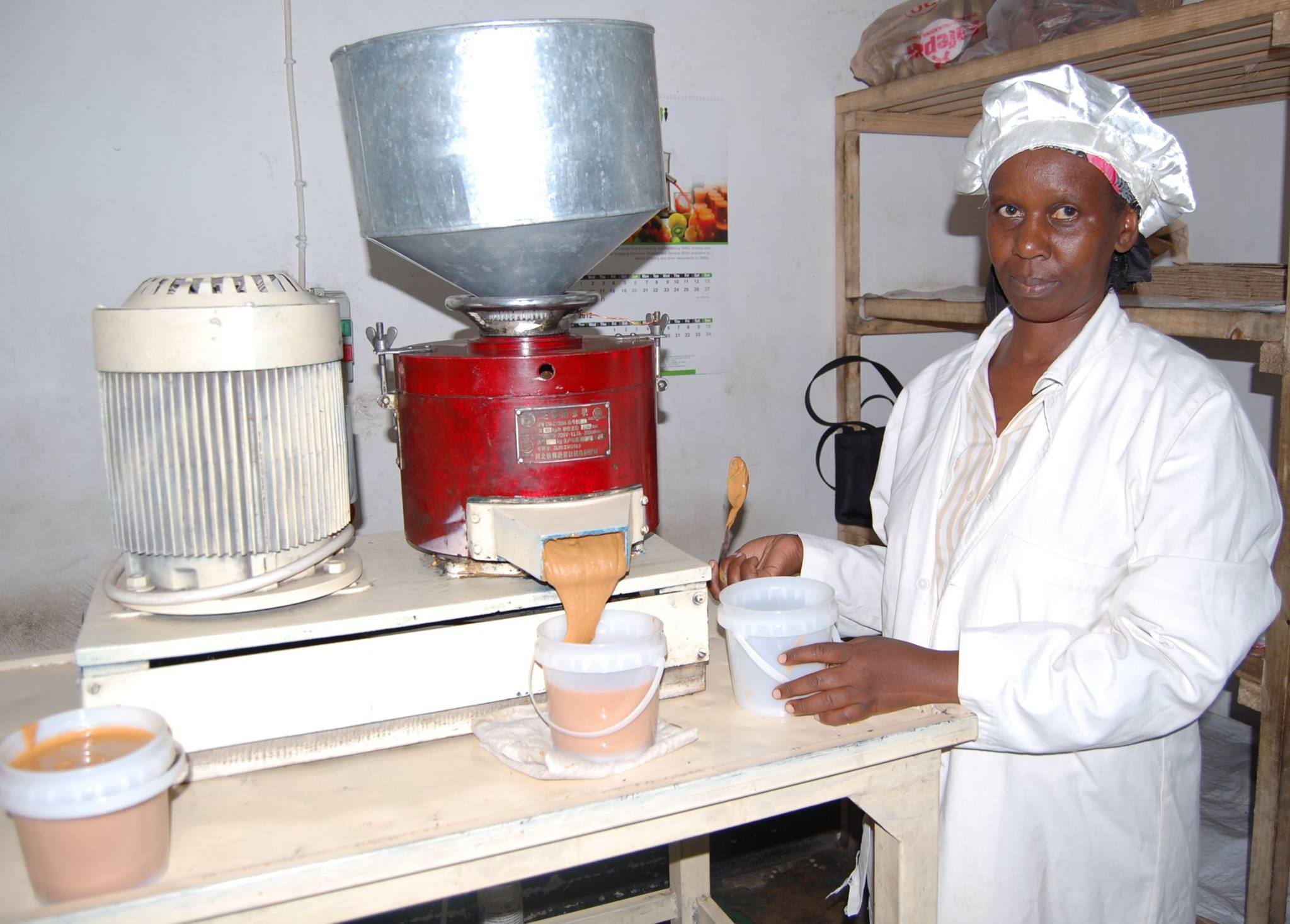 Woman next to a peanut butter maker