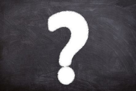 White chalk question mark on black chalkboard