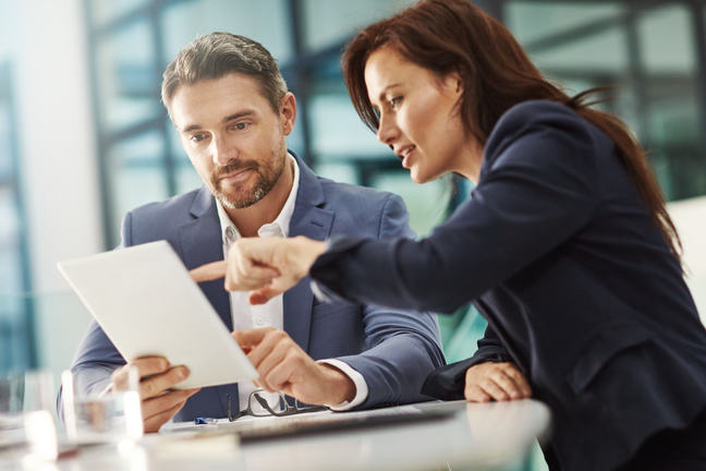 Woman and man discussing a document