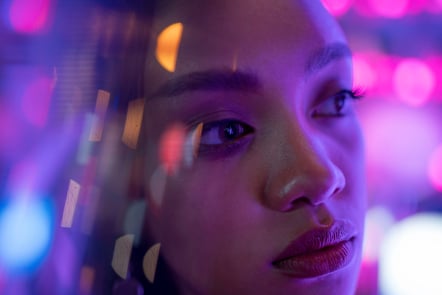 Portrait Of A Beautiful Asian Woman - Her Face Is Illuminated With Violet Light