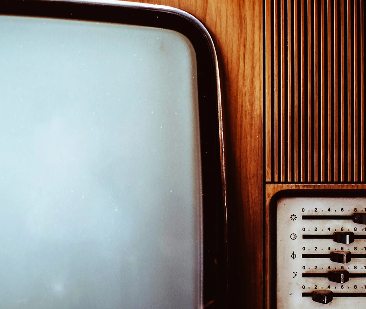 Close up of the sliding dials and wood grain on an old TV