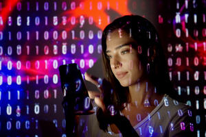 Code projected on a woman using a smart phone.