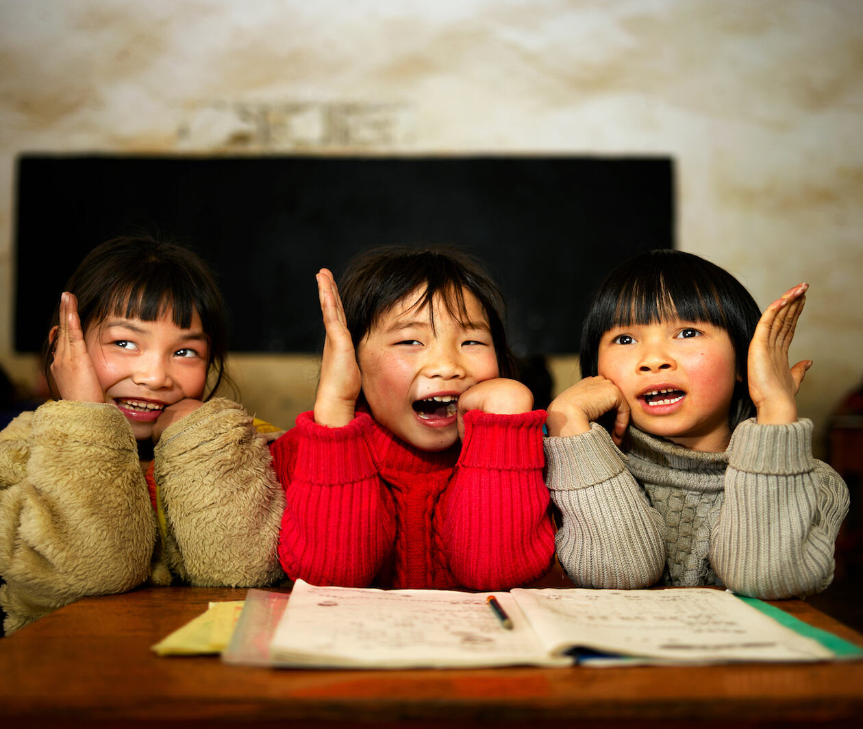 Three Chinese students in a classroom 