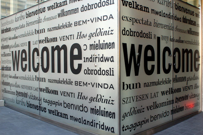 Cube with "Welcome" inscribed in multiple languages.