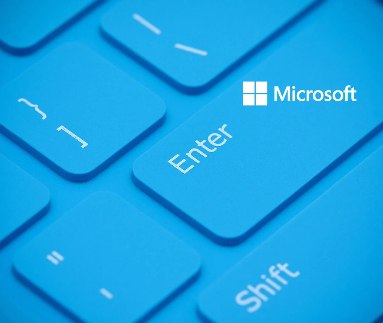 A bright blue keyboard with the words 'Enter' and 'Shift' in white and the Microsoft white logo in the top right corner..