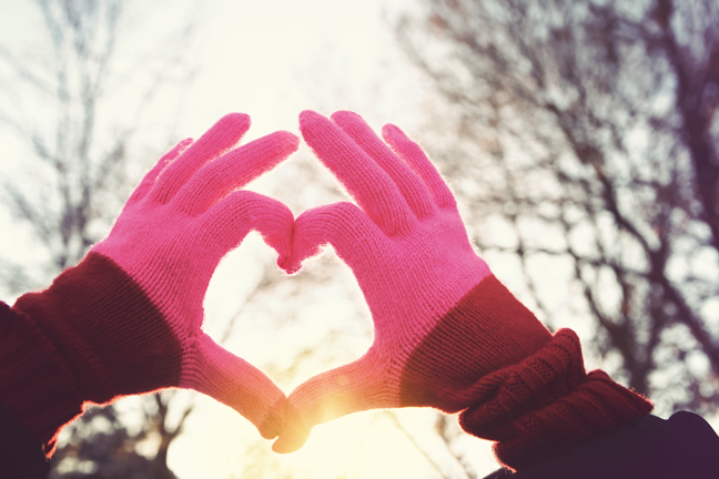 Hands held together to form heart shape