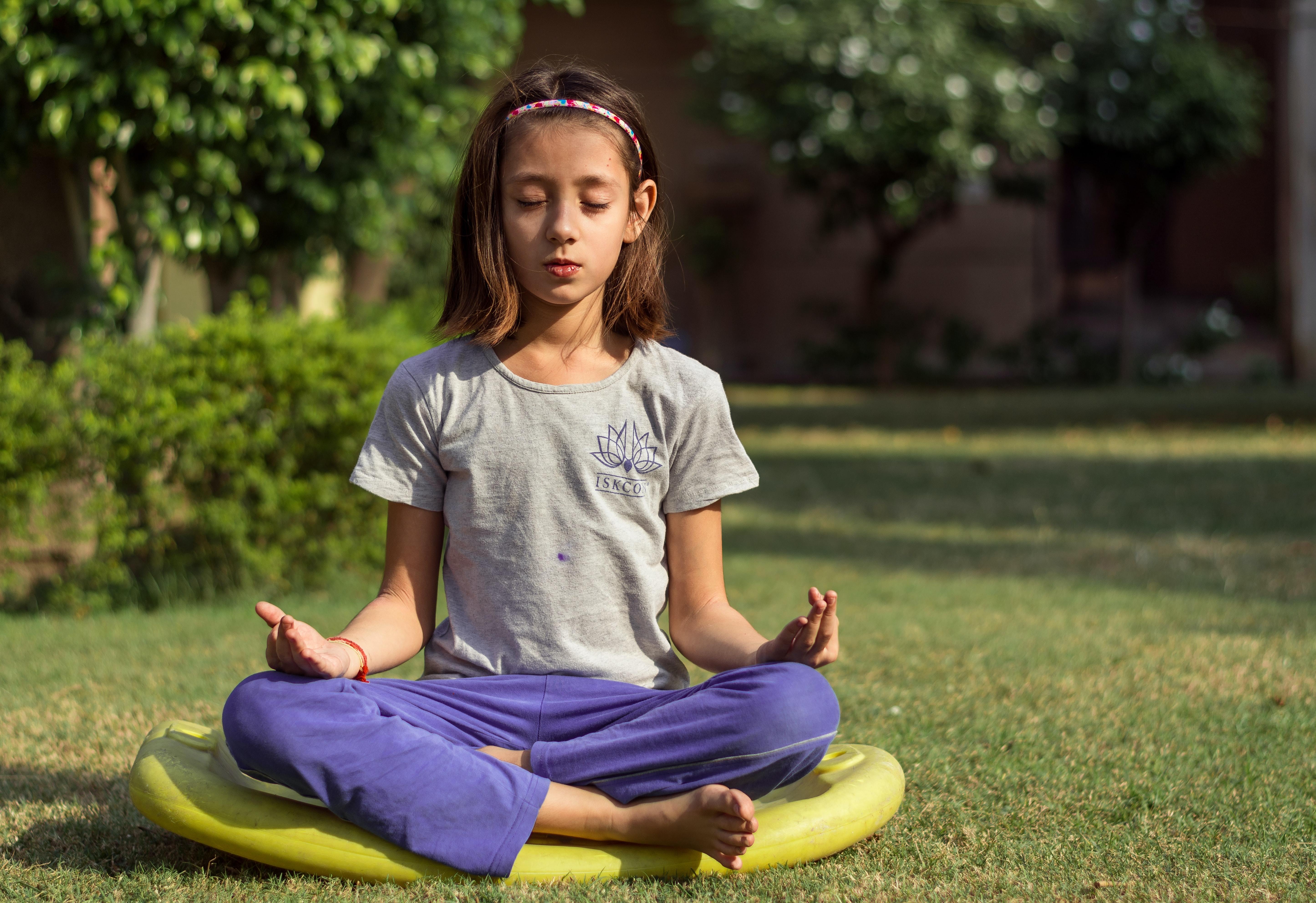 A young girl practicing meditation