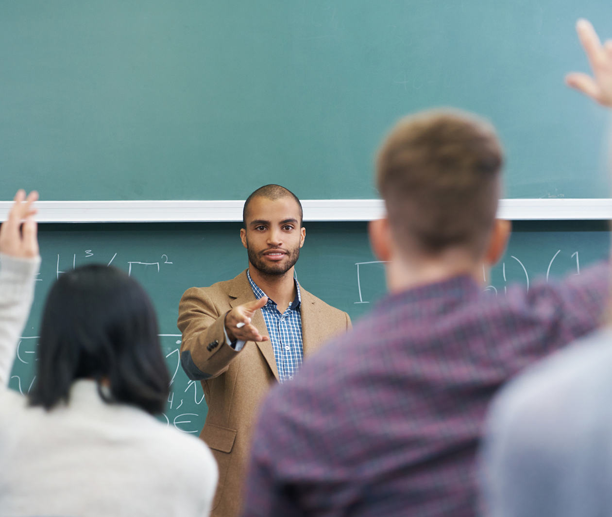 Teacher in front of class teaching mathematics