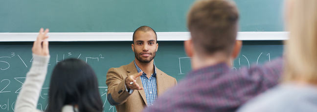 Teacher in front of class teaching mathematics