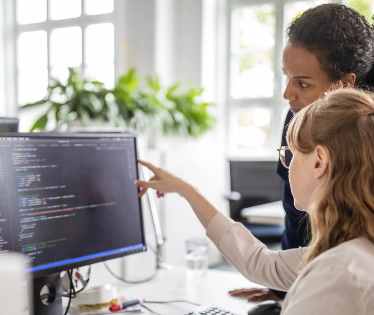 Two women looking at a computer