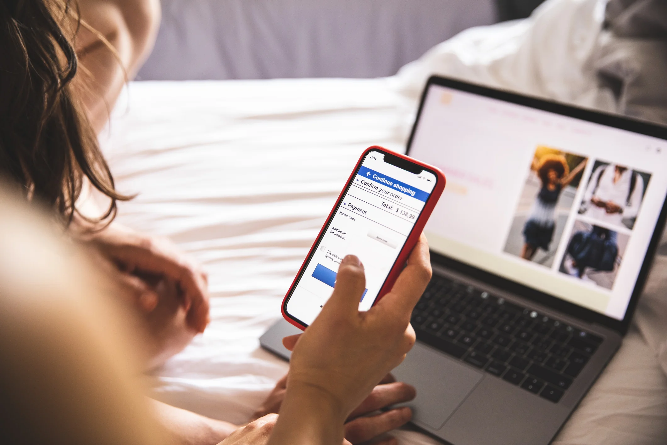 A person browsing an eCommerce shop on a laptop and phone. The payment page is visible.