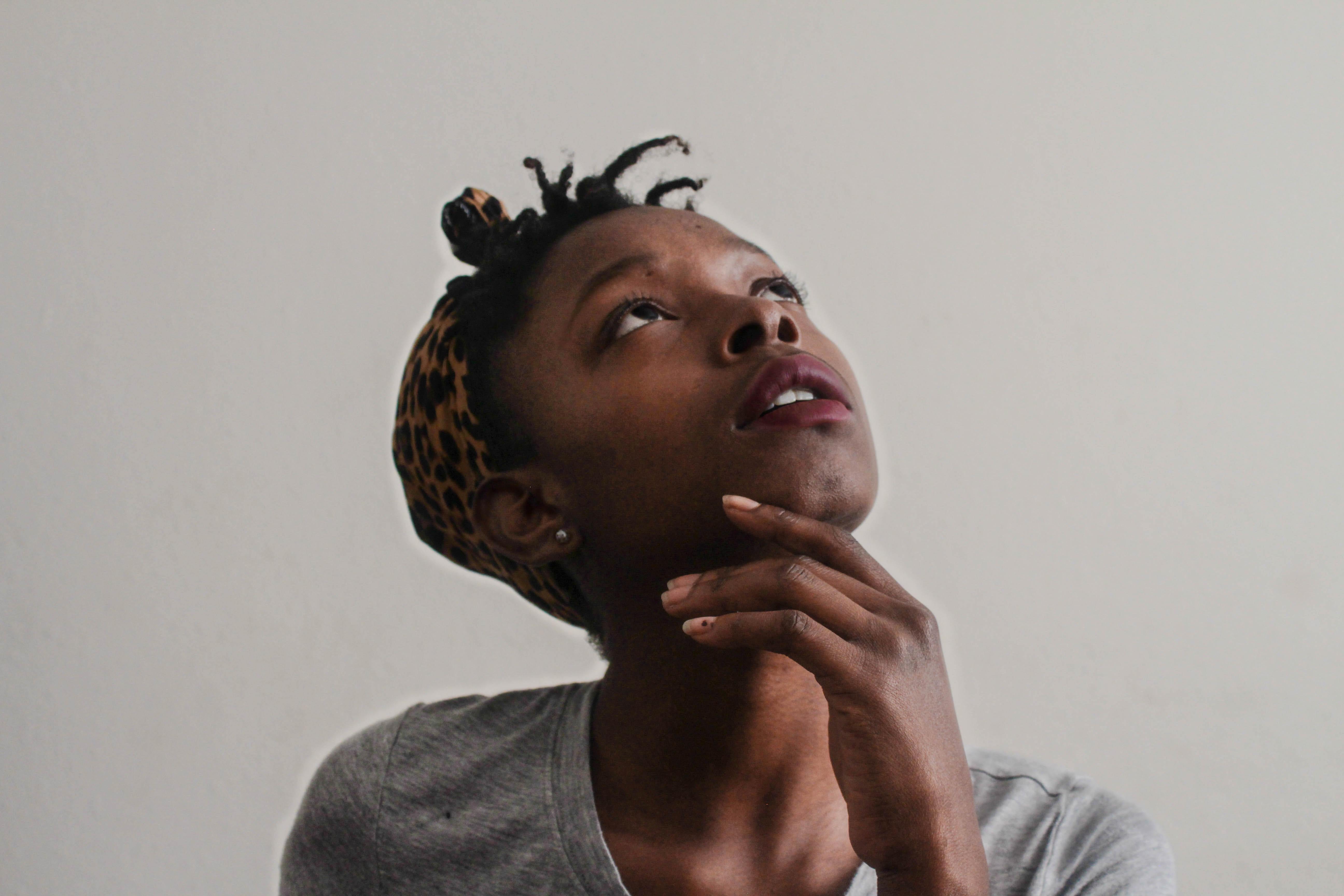 A young woman thinking and looking skyward