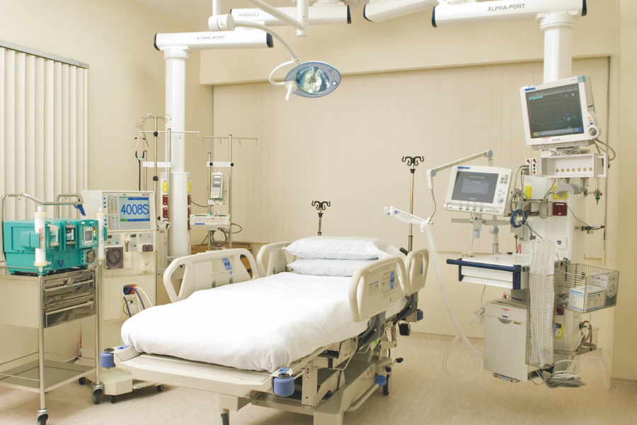 empty ICU bed with machines around it