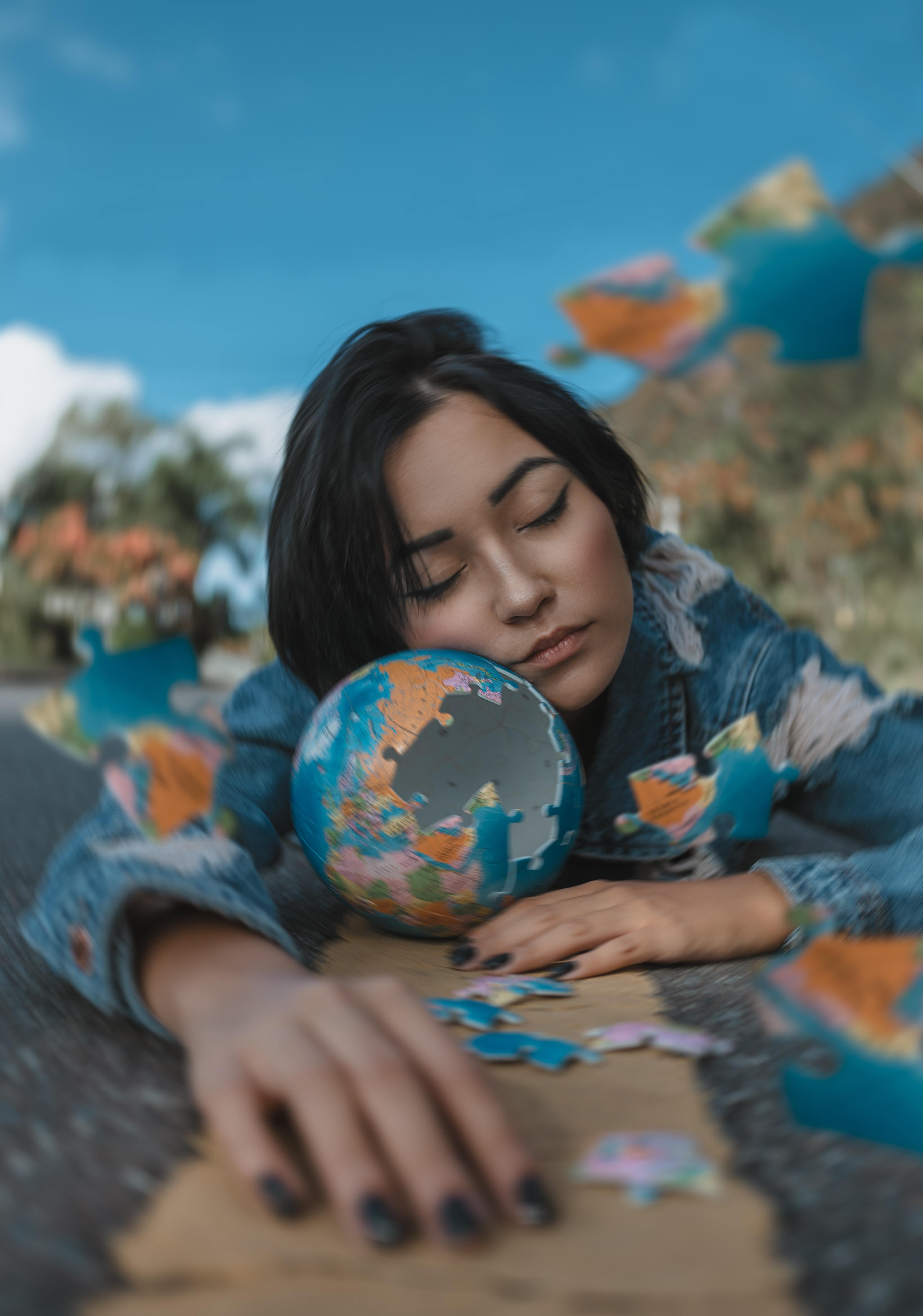 a photo of a woman holding a globe