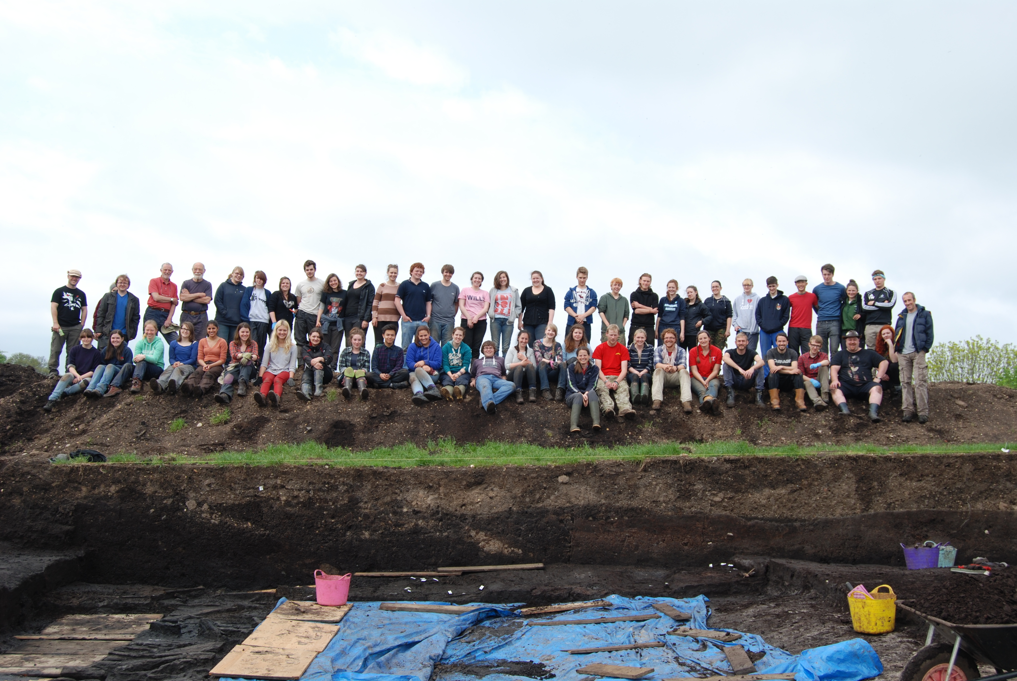 Students standing in a line on the side of the trench at Star Carr