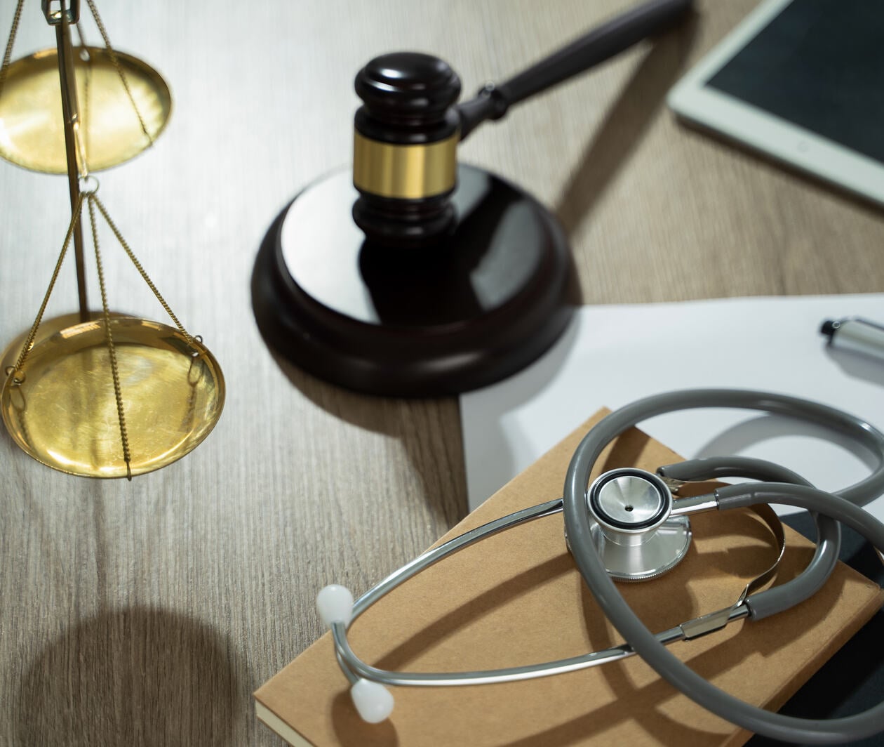 A doctor and a lawyer discussed health care, justice, and ethics in a clinic, balancing safety, rights, and responsibility