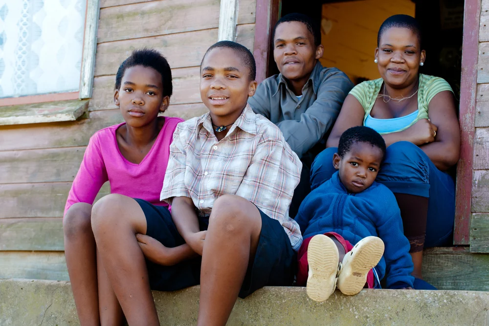 Family together - sitting on steps outside.