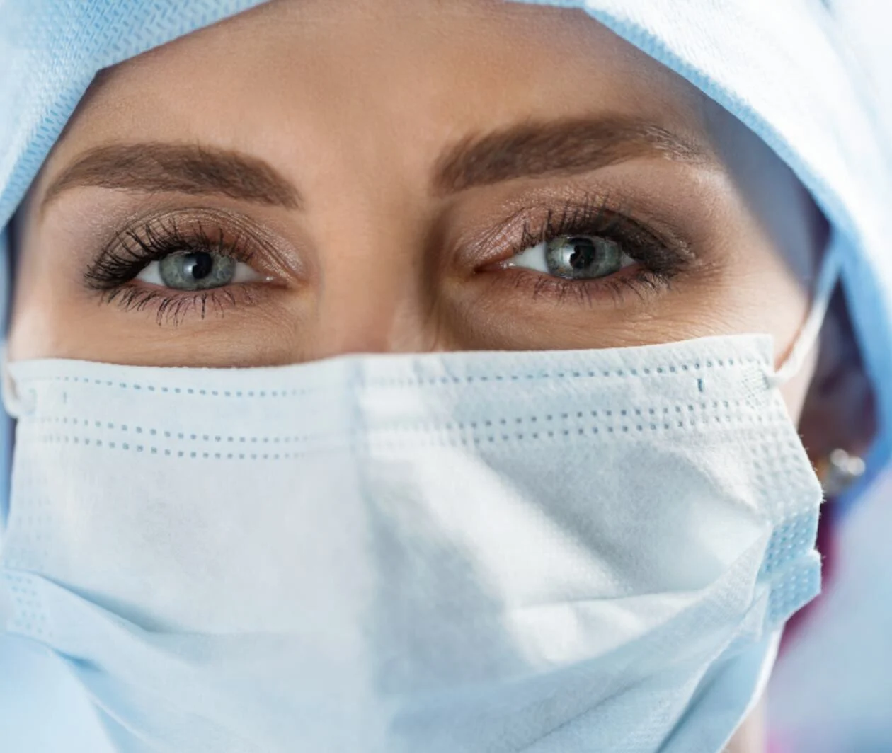 A veterinarian is wearing a protective face mask.