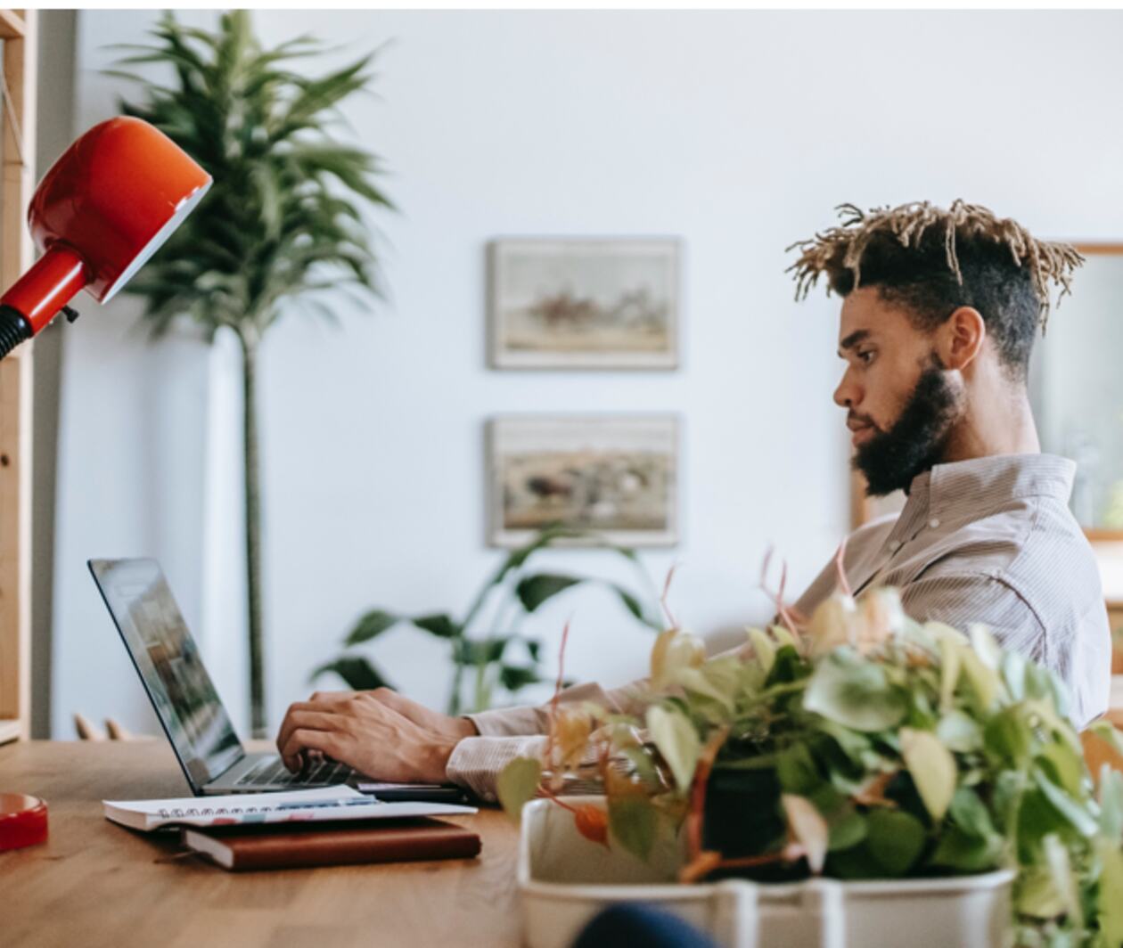 A man works on his laptop in his home