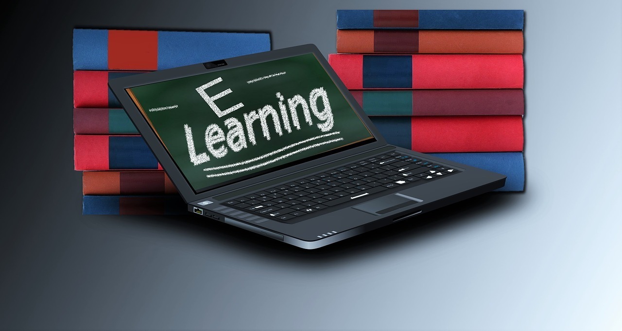 Laptop showing Image of books and laptop