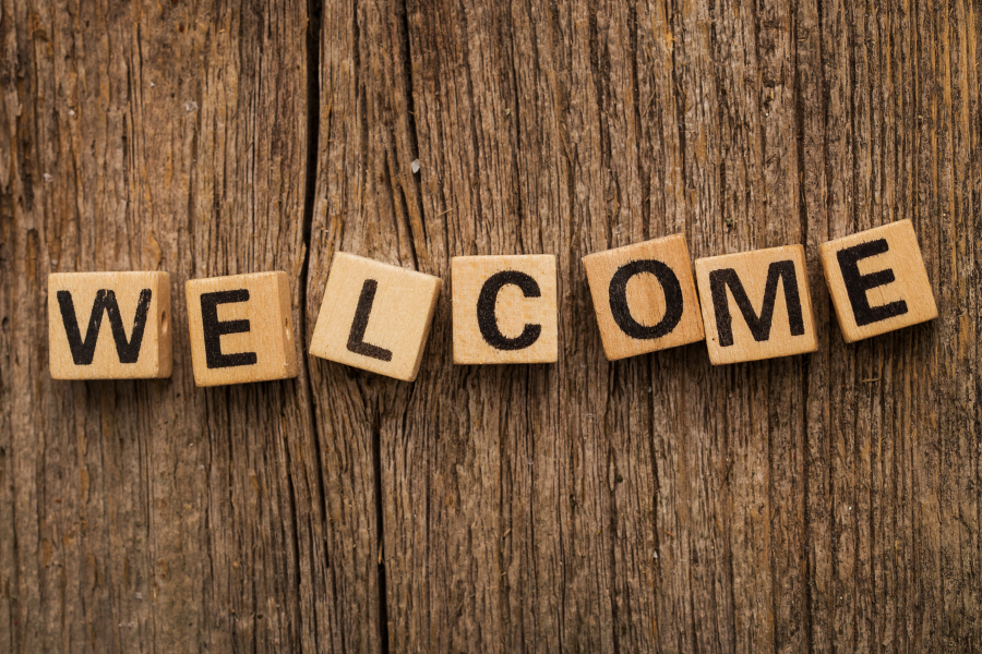 Toy bricks on a table, spelling out the word welcome