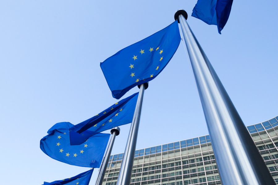 European flags in front of the Berlaymont building in Brussels. EU corporate commitments concept