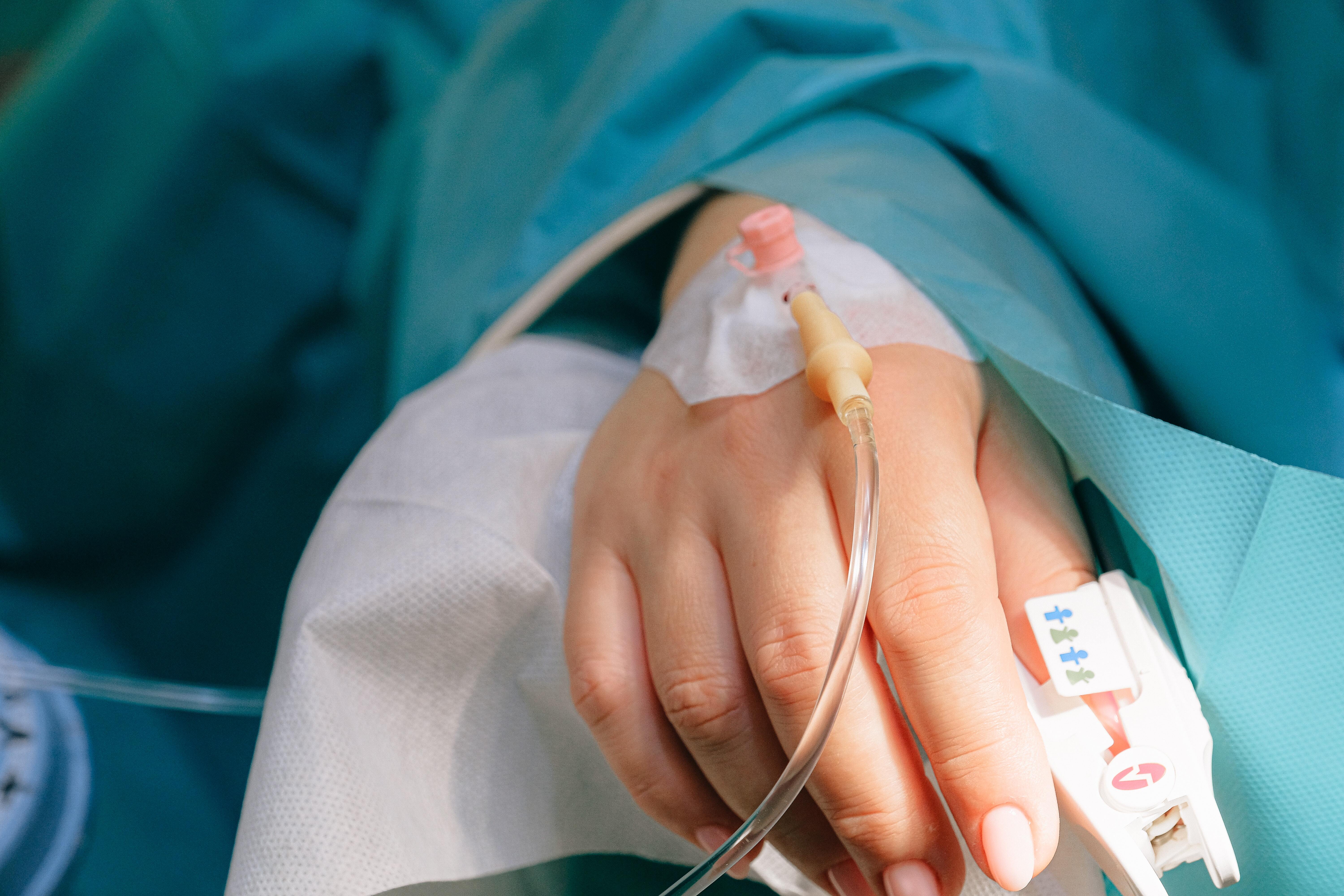 Patient's hand, with cannula and saturation probe attached