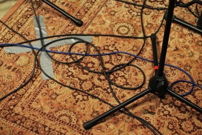 Microphone cables an stands on a persian carpet.